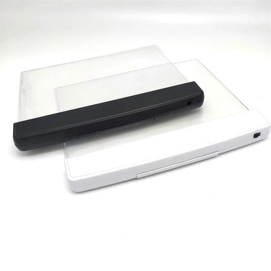 Ultra-slim LED page reading light illuminating an open book, portable acrylic book lamp for night reading.
two screens, one with black handle lies on top of another with white handle. all on the white backgound