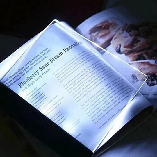 Ultra-slim LED page reading light illuminating an open book, portable acrylic book lamp for night reading.
led screen at angle on left page of the book with different text fonts, lighting to read page