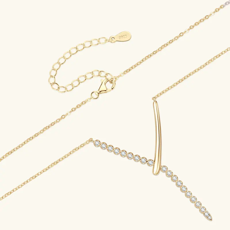 Gold necklace with a unique pendant on a white background